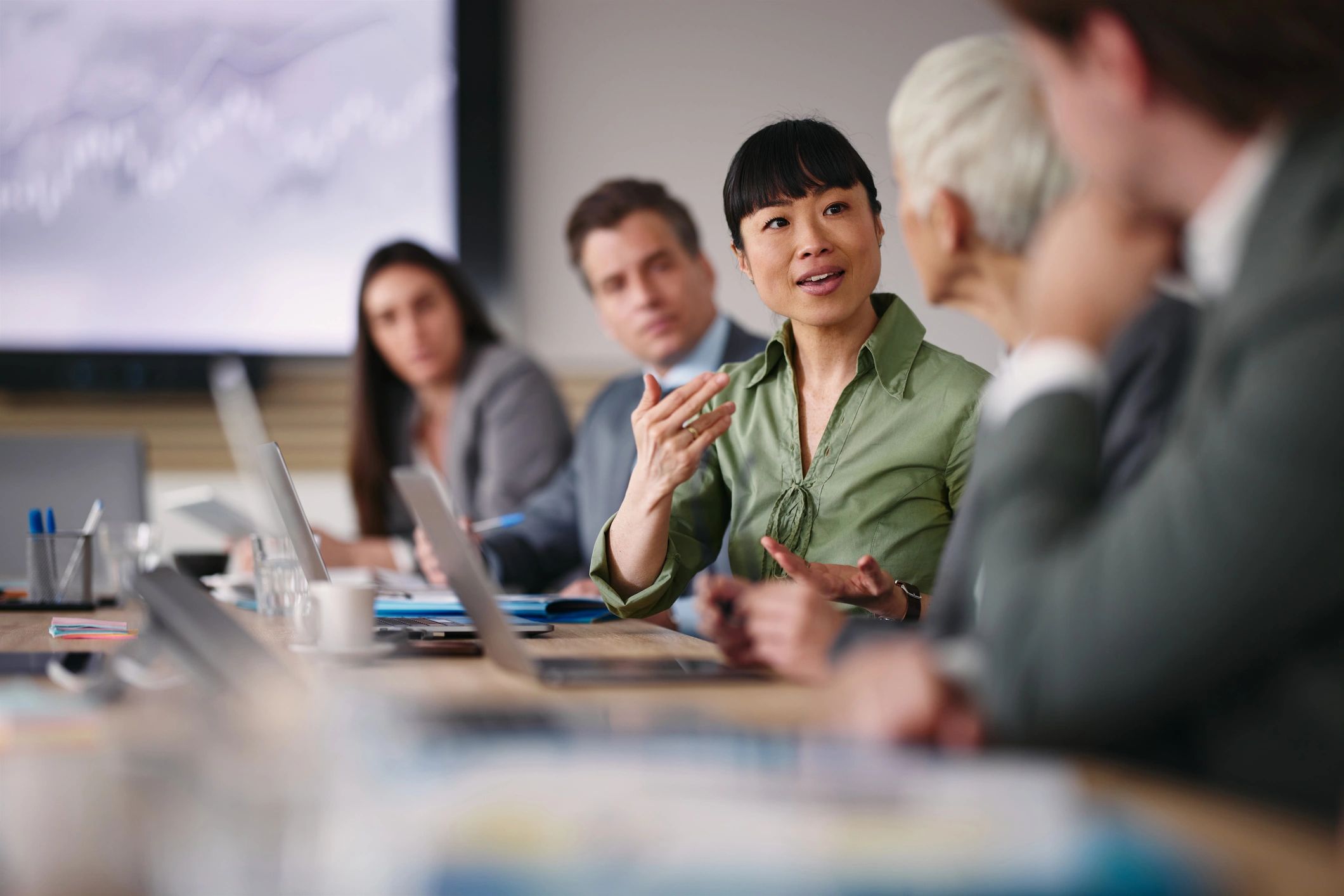 Professional businesswoman speaking with a colleague during an office meeting