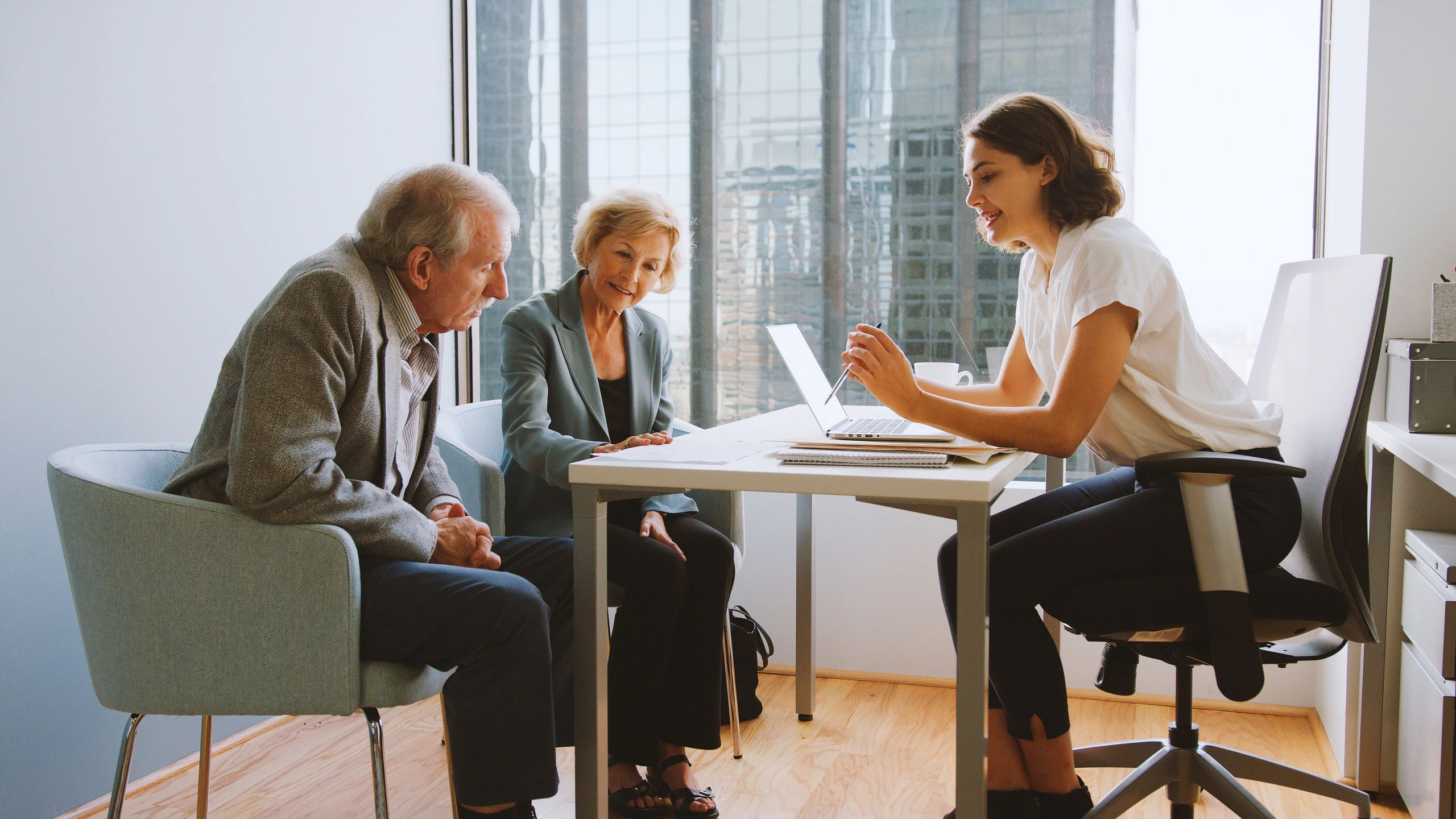 Financial advisor meeting with clients in an office