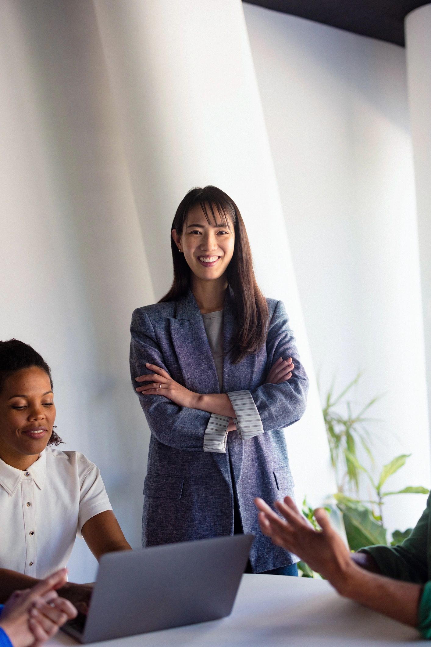 Confident female business leader standing during a team meeting